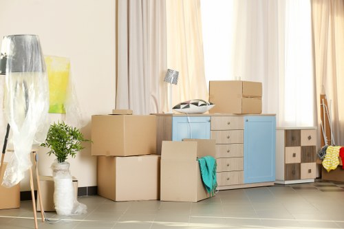 Professional house removalists working in Brent with moving van and boxes