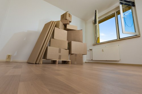 Organized moving boxes ready for transport in Brent