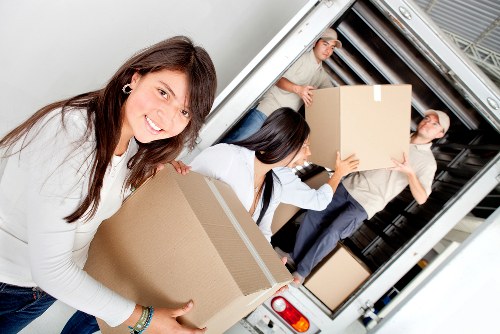 Team removing old furniture from a flat during Brent pick-up service